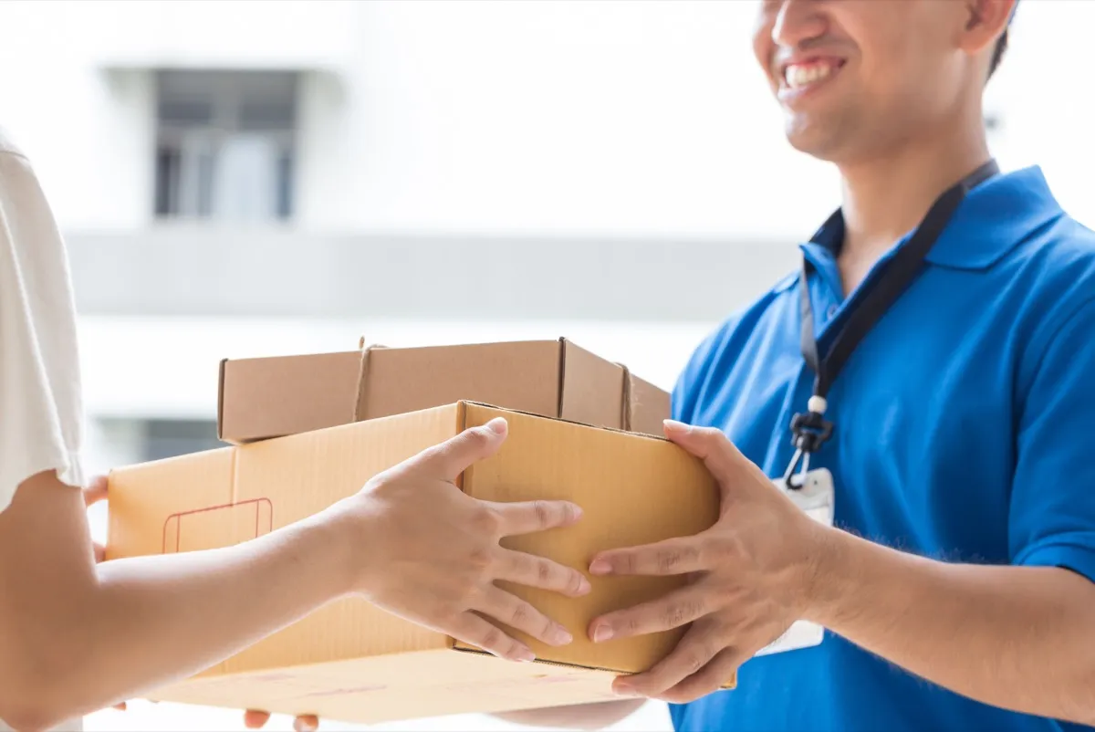 Asian-man-delivering-packages_shutterstock_402085021